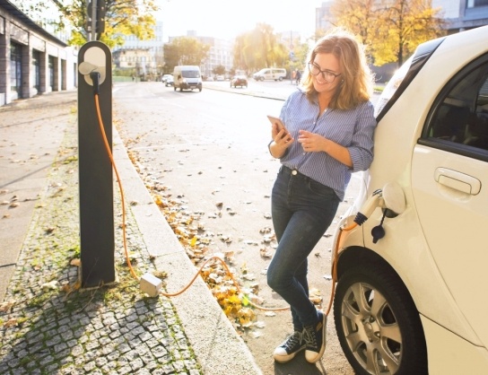 woman charging an electric vehicle
